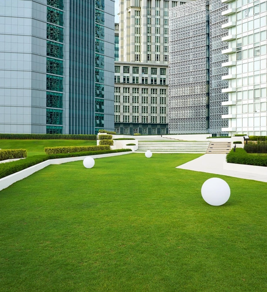 Professional commercial lawn maintenance for an office complex in Central Florida, showcasing pristine mowing and edging.