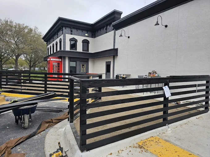 Black horizontal slatted commercial fence installation in Daytona Beach