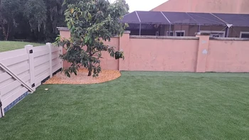Artificial turf lawn and new vinyl privacy fence installation