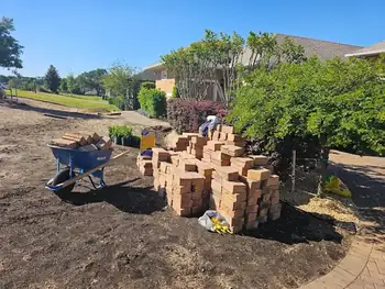 Florida-friendly landscaping preparation, showing base materials for pavers.