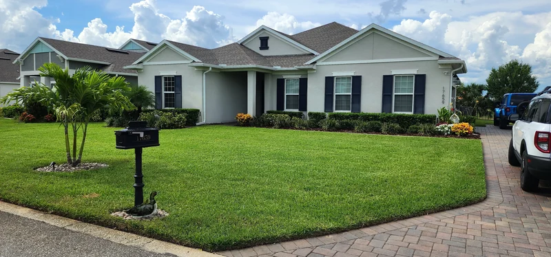 Custom paver driveway and beautiful lush green landscaping in Winter Park