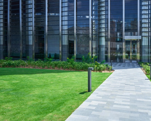 Precise mechanical edging and sidewalk cleanup at a commercial retail plaza to enhance curb appeal.