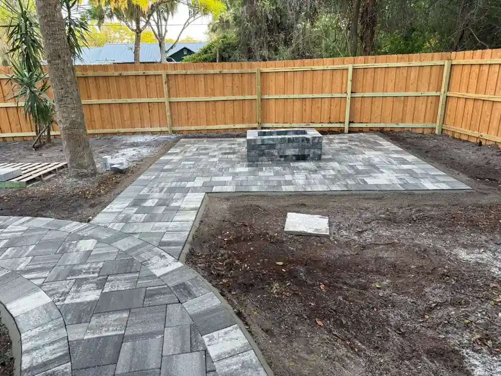 Custom-built stone paver fire pit and outdoor seating area installed by professional hardscaping contractors in Orlando.