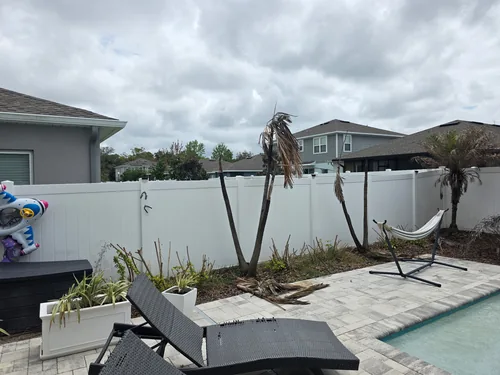 Back fence area in Daytona Beach before the new landscaping