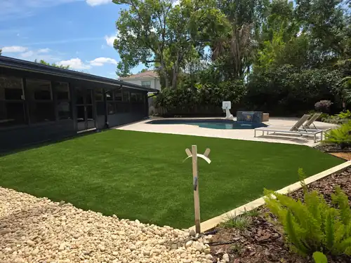 Fresh plantings framing the artificial turf in the Sanford backyard