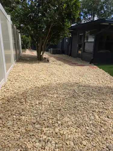 Decorative stone bordering the turf and plant beds in the Sanford backyard