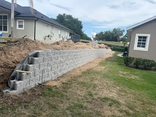 Finished retaining wall in a Windermere yard after installation