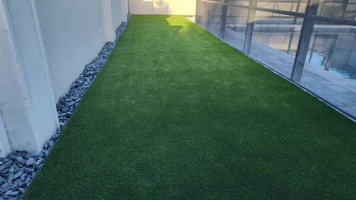 Backyard in Winter Park with new artificial turf, paver walkway, and fresh sod