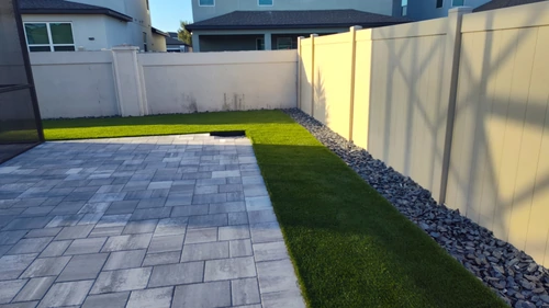 Right side of the Winter Park yard showing turf meeting the paver path