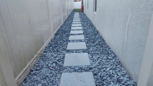 Paver walkway running through artificial turf in a Winter Park backyard