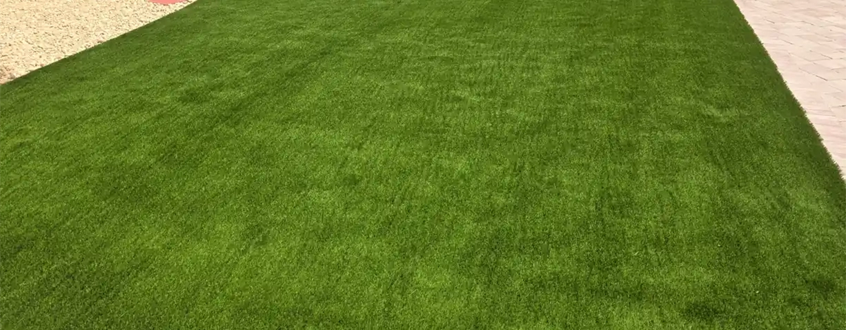 Professional backyard artificial turf installation in Sanford, Central Florida, showcasing a vibrant, precision-laid synthetic grass lawn.